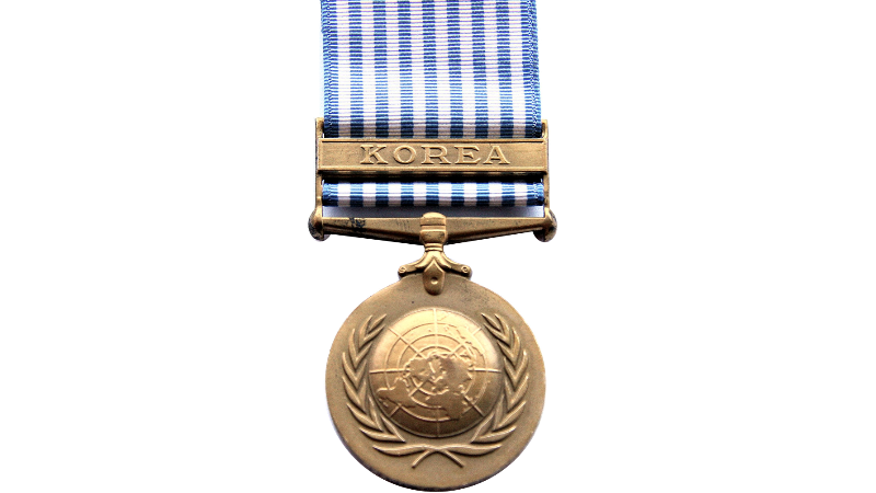 Gold medal with pale blue and white striped ribbon and laurel wreath design