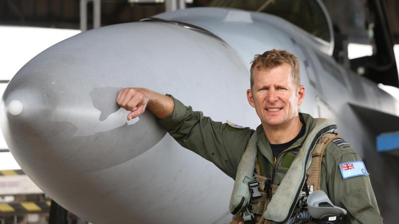 No. 1 Squadron Executive Officer Squadron Leader Luke Warner with an F/A-18F Super Hornet. Photo: Corporal Colin Dadd