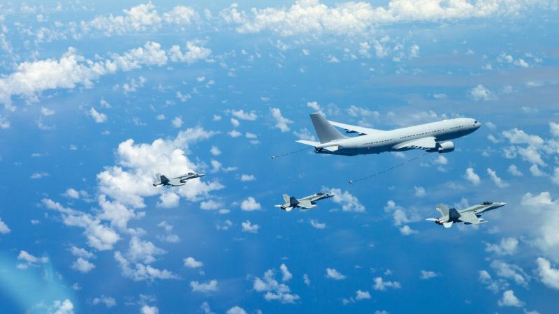An Air Force KC-30A multi-role tanker transport A39-005 aircraft conducts an air-to-air refuelling serial with two F/A-18A Hornets during the Regional Presence deployment. 