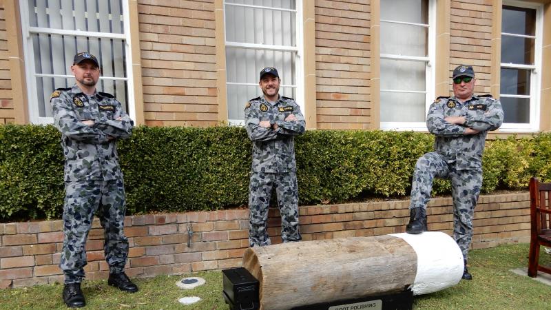 Petty Officer Boatswain Brendon Chafer, left, Leading Seaman Boatswains Mate Steven Reig and Leading Seaman Boatswains Mate Bradley Reynolds with one of the boot-cleaning stations at HMAS Penguin. Photo: Lieutenant Anthony Martin