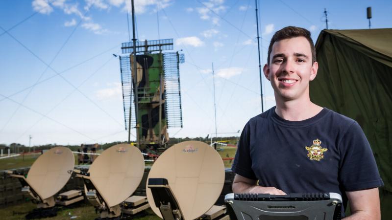 Leading Aircraftman Nick Brown monitors the satellite link back to RAAF Williamtown from the Corindi showgrounds. Photo: Corporal Craig Barrett