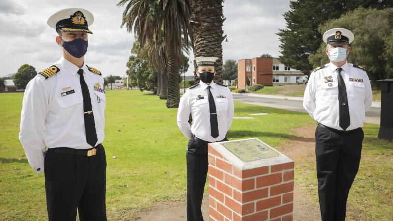 Commanding Officer HMAS Cerberus Captain Mike Oborn, Leading Seaman Jodi Farmer and HMAS Cerberus Command Warrant Officer Michael Connors with the commemorative plinth marking 100 years of service. Photo: Leading Seaman Bonny Gassner
