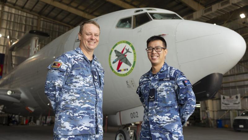 Sergeant Nathan Bradford, left, and Leading Aircraftsman Sam Chan with their nose-art design on an E-7A Wedgetail in the Middle East region. Photo: Corporal Tristan Kennedy 