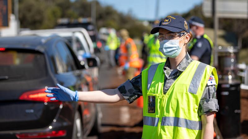 Midshipman Madeline Moroney directs vehicles through the Gisborne South Vehicle checkpoint during Operation COVID-19 Assist. Photo: Private Olivia Cameron