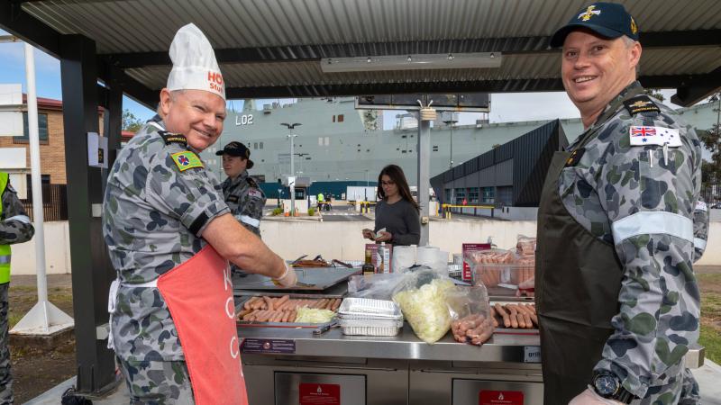 Senior Chaplain Paul Stuart, left, and Chaplain Jon-Paul Barry cook up a storm on the barbecue to support Defence members for R U OK?Day at HMAS Kuttabul. Photo: Able Seaman Benjamin Ricketts