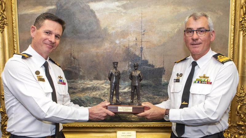 Rear Admiral Mark Hammond hands over 'the weight' of command to newly appointed Deputy Chief of Navy Rear Admiral Christopher Smith at a ceremony at Navy Headquarters in Canberra. Photo: Leading Seaman James McDougall