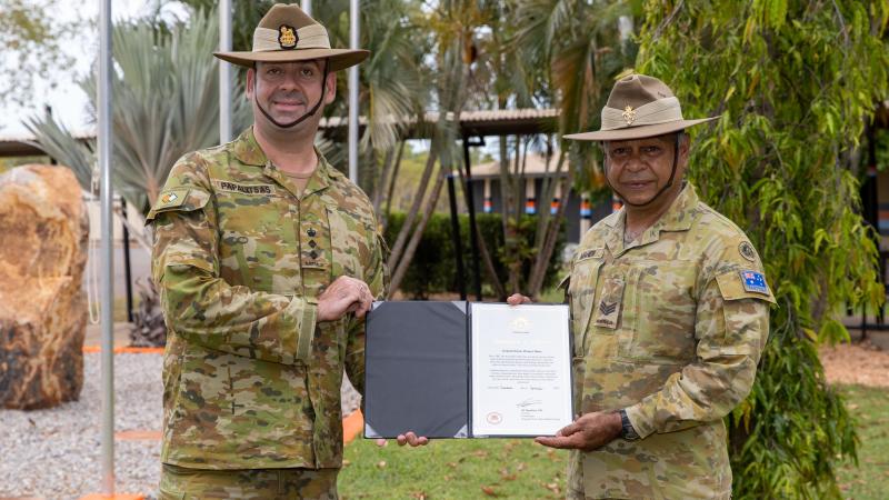 Australian Army Commander Regional Force Surveillance Group Colonel John Papalitsas presents Sergeant Dennis Maher with a certificate of appreciation for more than 30 years of service.