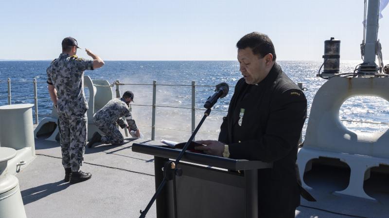 Chaplain Simote Finau and crew of HMAS Adelaide conduct a scattering of ashes memorial service. Photo: Able Seaman Sittichai Sakonpoonpol