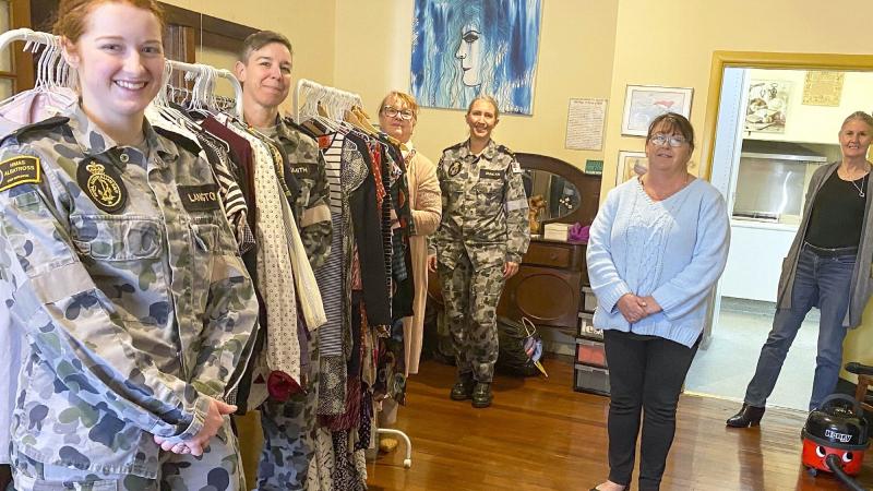 Able Seaman Sophie Langton, left, Petty Officer Casey Smith, Petty Officer Cassandra Duncan and Chief Petty Officer Linda Eddington, with Supported Accommodation and Homelessness Services Shoalhaven & Illawarra volunteers, setting up a donation point.