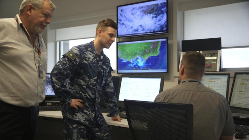Defence decision support meteorologists brief an Air Force officer on forecast aviation weather conditions for the day at RAAF Base East Sale. 