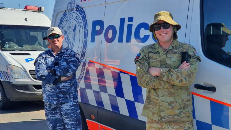 Sergeant Ben Pedersen, left, and Leading Aircraftman Bryce Eldredge support a NSW Police checkpoint at Chaffey Bridge near Mildura during Operation COVID-19 Assist.