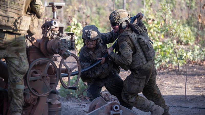 Gunner Thalia Tabuai, right, of 8th/12th Regiment, Royal Australian Artillery, and US Marine Corps Corporal Kevin Dominic Matias ram a high-explosive projectile into the breach of an M777A2 Howitzer. Photo: Corporal Rodrigo Villablanca 
