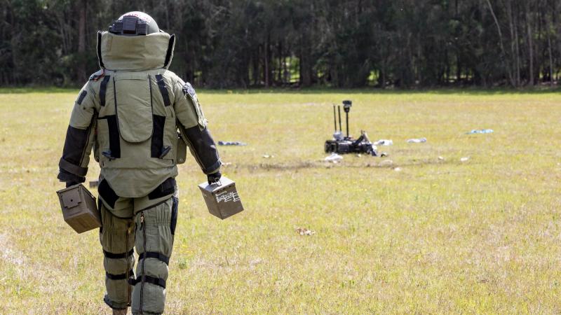Corporal Randell Costello walks out in an EOD-9 bomb suit to a simulated explosive device during Exercise Regal Burrow at Defence Establishment Orchard Hills. Photo: Corporal Dan Pilhorn 