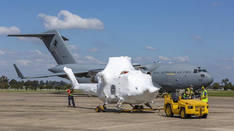 The NSW Rural Fire Service’s new Bell 412 helicopter is towed to a hangar after being unloaded from a RAAF C-17A Globemaster III at RAAF Base Richmond. Photo: Corporal Dan Pinhorn