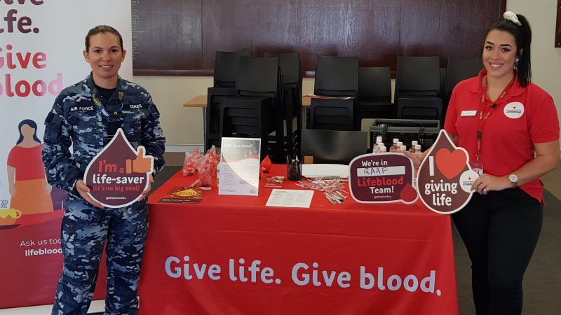 Flight Lieutenant Tramaine Dukes with an Australian Red Cross Lifeblood representative at RAAF Base Pearce, WA, during the 2020 Defence Blood Challenge.