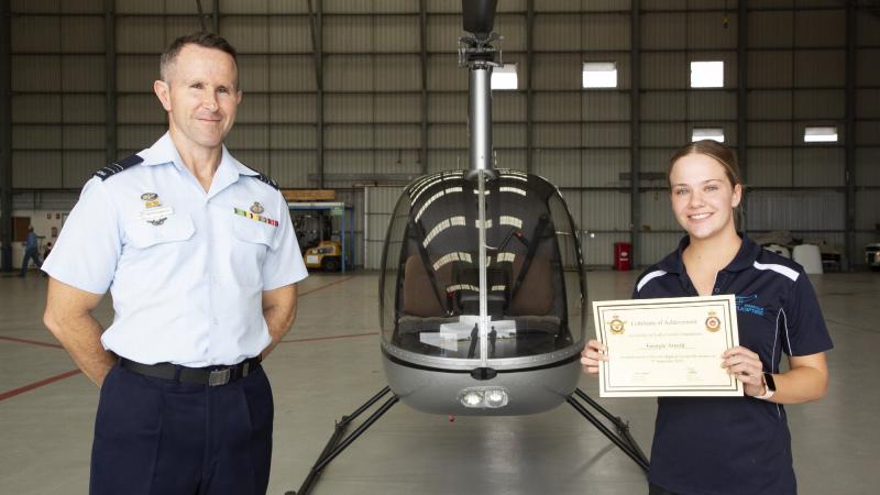 Senior Air Traffic Controller at No. 452 Squadron, Squadron Leader Peter O’Connell  presents Georgie Arnold with her certificate on completing her first solo flight. Photo: Corporal Colin Dadd