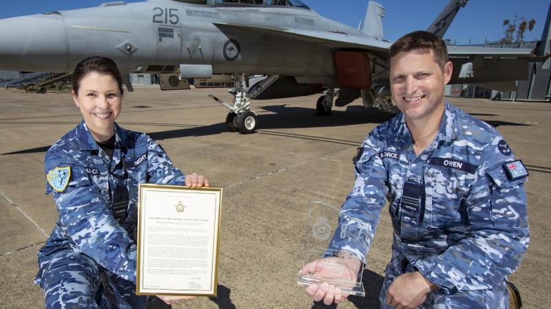 Flight Lieutenant Knight receives the Max Cowin Award from her supervisor Squadron Leader Geraint Owen. Photo: Corporal Jesse Kane