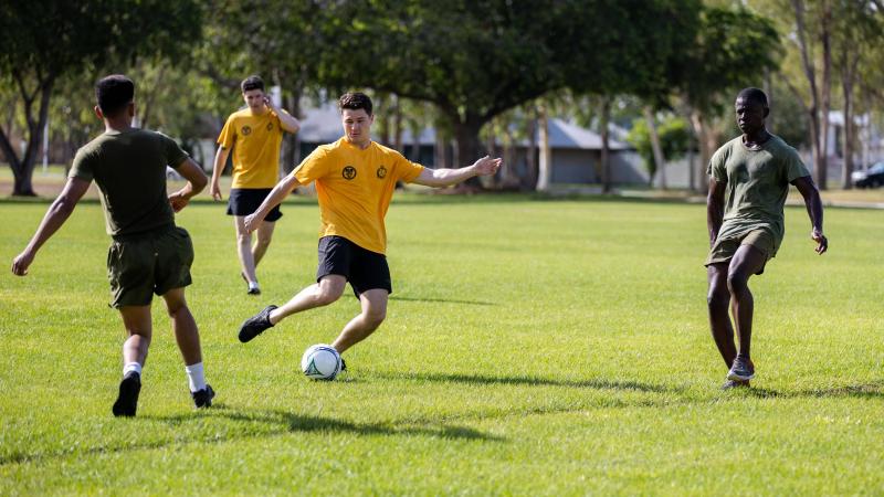 A member of 5RAR passes the ball during a soccer match at the annual Sports Day held at Robertson Barracks, Northern Territory. Photo: Corporal Rodrigo Villablanca 