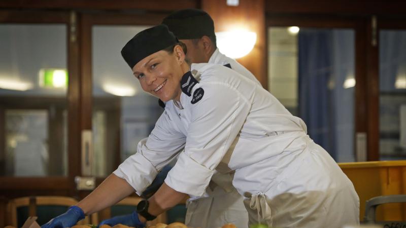 Corporal Sheree Woodward assists in the preparation of lunchtime salad rolls at RAAF Base Darwin. Photo: Sergeant Ben Dempster