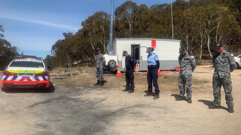 Warrant Officer Troy Eather, Able Seaman Luke Hill and Able Seaman Nathan Steynberg with two NSW Police Force officers pause for a minute's silence during Operation COVID-19 Assist. 