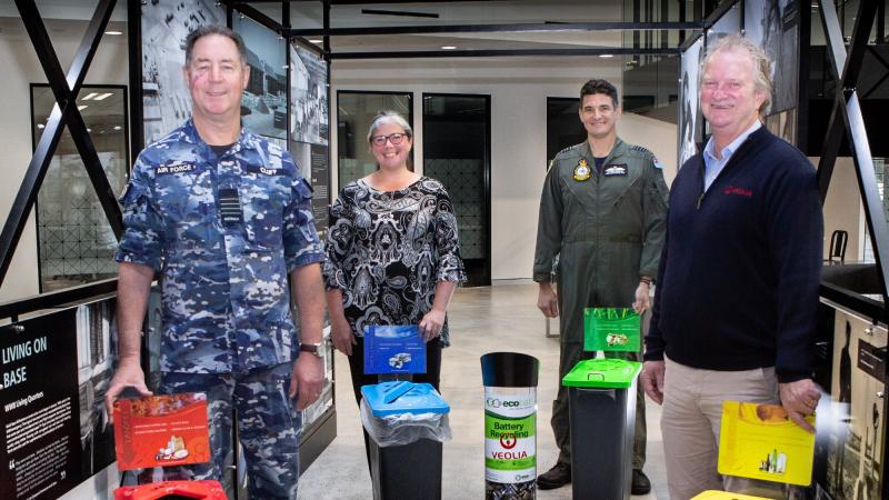  RAAF Base Williamtown Group Captain Peter Cluff, left, base manager Mary-Anne Mellor, Group Captain Nathan Christie and Veolia representative Brad Bowman with waste-management bins at RAAF Base Williamtown. Photo: Sergeant Guy Young