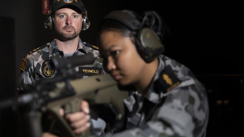 Leading Seaman Bradley Reynolds supervises Able Seaman Armilyn Pontanes during a live-fire serial at the new Weapons Training Simulation System at HMAS Penguin. Photo: Leading Seaman Nadav Harel