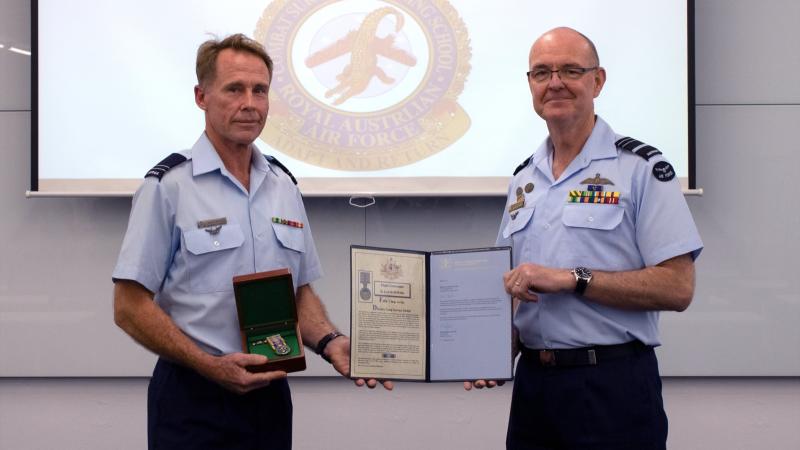 Flight Lieutenant Bruce Lowth, left, being presented his Federation Star by Chief of Joint Capabilities Air Marshal Warren McDonald at Combat Survival Training School at RAAF Base Townsville.