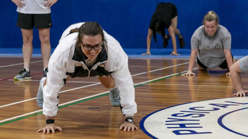 Leading Seaman Jessica Fisher in training at the at the Garden Island gymnasium, Sydney, in preparation for the burpee challenge in support of breast cancer research. Leading Seaman Leo Baumgartner