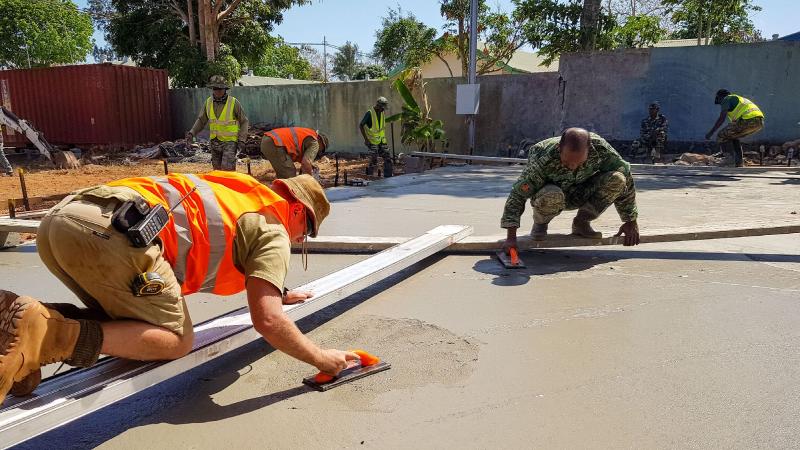 Corporal Gary Beattie, left, works alongside Timor-Leste Defence Force soldiers on a construction site during Exercise Hari'i Hamutuk 2020. Photo: Captain Caitlin McDermid 