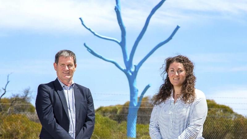 Regional Mental Health Manager ADF Centre for Mental Health Paul Blakley and Mental Health Promotions Coordinator Ali Freesmith in front of the blue tree erected at HMAS Stirling, Western Australia. Photo: Petty Officer James Whittle