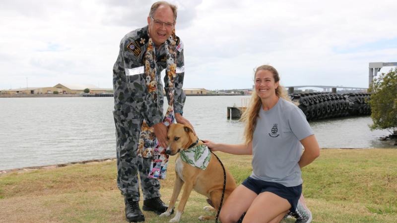 Chaplain Stephen Briggs with dental officer Lieutenant Anthea Baczkowski and her dog Paco during the blessing of the animals ceremony at HMAS Moreton. 
