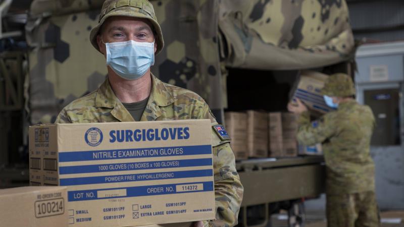 Private Jason Jackson from 4th Combat Service Support Battalion, loads stores onto the back of a G-Wagon. Photo: Sergeant Kirk Peacock