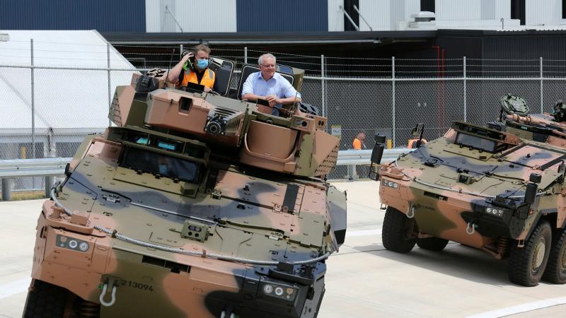 Prime Minister Scott Morrison was given a test drive in the Boxer Combat Reconnaissance Vehicle during the opening ceremony of Rheinmetall Defence Australia’s Military Vehicle Centre of Excellence in Queensland. Photo: Corporal Nicci Freeman