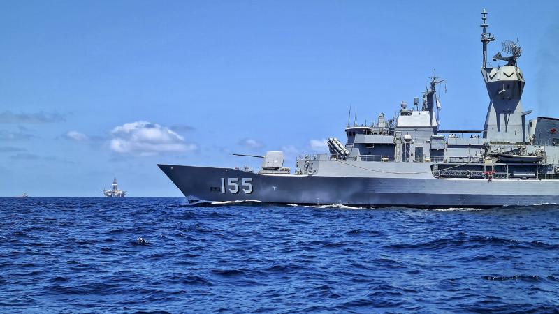 HMAS Ballarat patrols past a large offshore gas platform off the north-west coast of Western Australia. Photo: Able Seaman Connor Webber