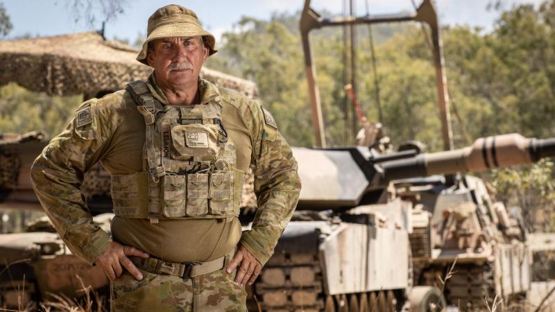 WO2 Terry Lemmon, from the 2nd/14th Light Horse Regiment, in front of an M1A1 Abrams tank at Shoalwater Bay, Queensland. Photo: Trooper Jonathan Goedhart