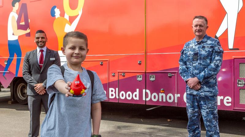 Josh Miller with his father, Wing Commander Peter Miller, and Australian Red Cross Lifeblood Group Account Manager Ronny Maroun at the mobile donor centre in Richmond, NSW. Photo: Corporal Dan Pinhorn