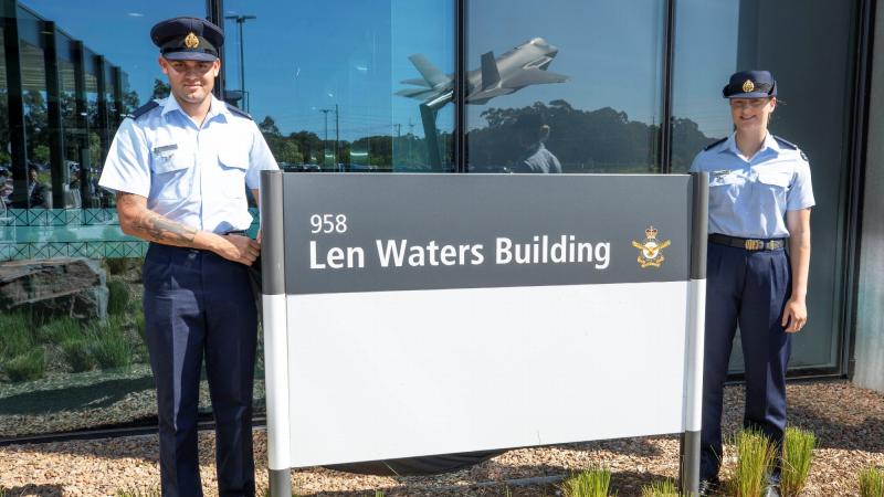 Aircraftman Steven Ahoy and Aircraftwoman Ellie Wallace unveil the Len Waters Building sign at RAAF Base Williamtown. Photo: Corporal Brett Sherriff