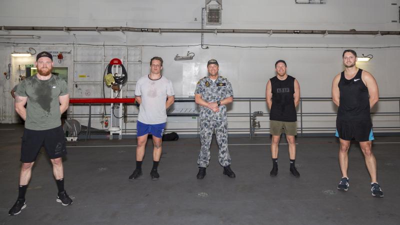 Commanding Officer HMAS Adelaide Captain Jonathan Ley, middle, with the winning team 'MT Kiwi' during the Gladiator Games 2020. Photo: Able Seaman Daniel Goodman