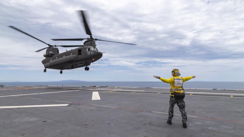 A Singapore Air Force Chinook lands on-board HMAS Adelaide off the coast of Townsville, Queensland. Photo: Leading Seaman Hadav Harel