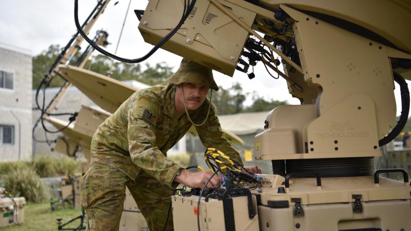 Signaller Jordan Massari, from the 1st Signal Regiment, sets up a communication link for Exercise Vital Prospect 2020. Photo: Sergeant Kim Allen