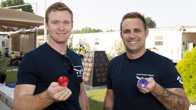 Leading Aircraftman Kyle Buckley, left, and Leading Aircraftman Matthew Kohl with their handmade metal poppies at Camp Baird in the Middle East. Photo: Corporal Tristan Kennedy