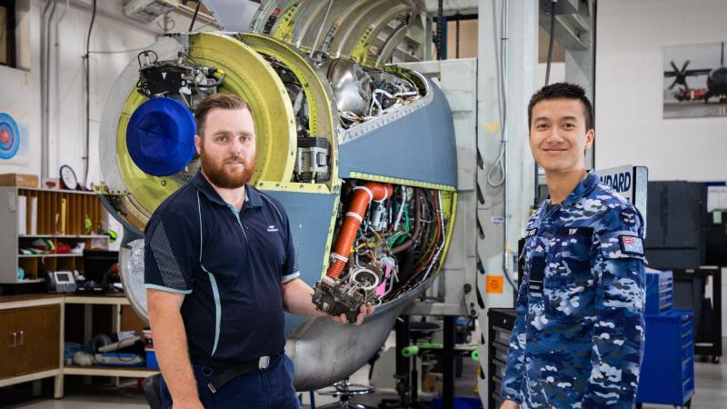 RAAF aeronautical engineer Flying Officer Kelvin Yim, right, with Thomas Chambers, from Standard Aero Limited, in the Standard Aero warehouse at RAAF Base Richmond. Photo: Aircraftman Adam Abela