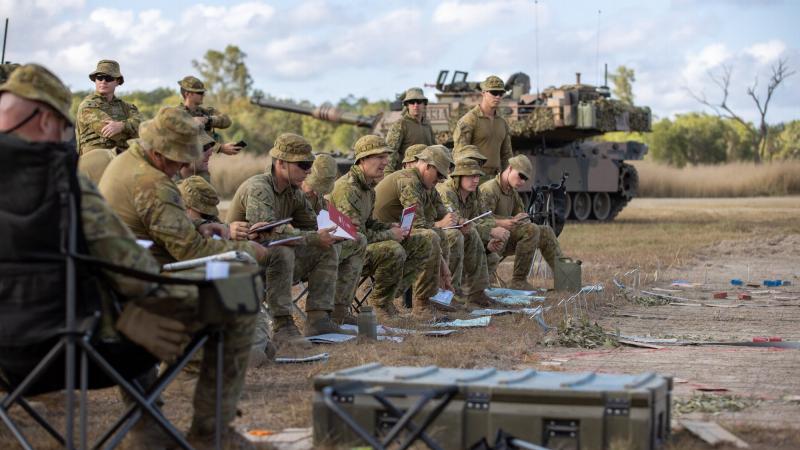 Officers of 7th Combat Brigade receive orders before stepping off on Exercise Diamond Catalyst at Shoalwater Bay Training Area, Queensland. Photo: Trooper Jonathan Goedhart