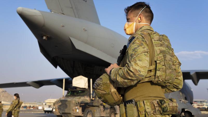 RAAF Corporal Daniel Cafaro guards a RAAF C-17 at Hamid Karzai International Airport in Kabul, Afghanistan. Photo: Corporal Tristan Kennedy