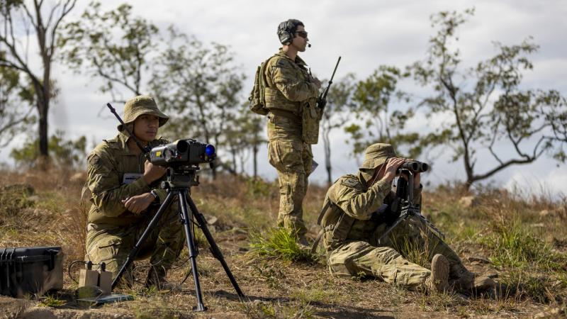 Army Gunner Emmanuel Gomapas, left, and Bombardier Michael Neilson, right,, from the 4th Regiment, Royal Australian Artillery, with Air Force Flight Lieutenant Ebrahim Tabandeh during Exercise Nigrum Pugio. Photo: Captain Lily Charles