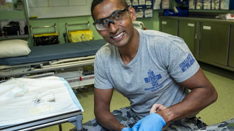 RAN nursing officer Lieutenant Commander Roneeel Chandra prepares to treat a patient on board HMAS Adelaide during Exercise Sea Wader. Photo: Leading Seaman Nadav Harel
