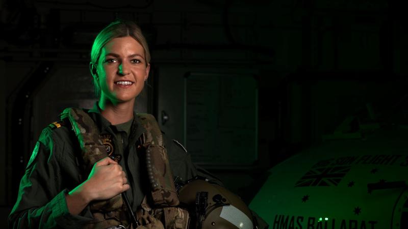 Maritime Aviation Warfare Officer Sub Lieutenant Ashley Hill in front of the MRH-60 helicopter embarked in HMAS Ballarat. Photo: Leading Seaman Shane Cameron 
