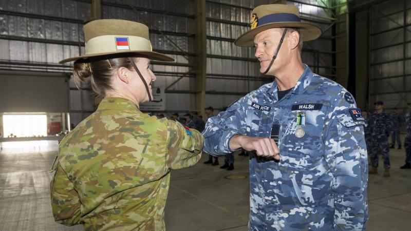 Commander of Joint Task Force 633 Major General Susan Coyle congratulates Wing Commander Matthew Walsh during a Transfer of Authority parade at Camp Baird in the Middle East. Photo: Corporal Tristan Kennedy 