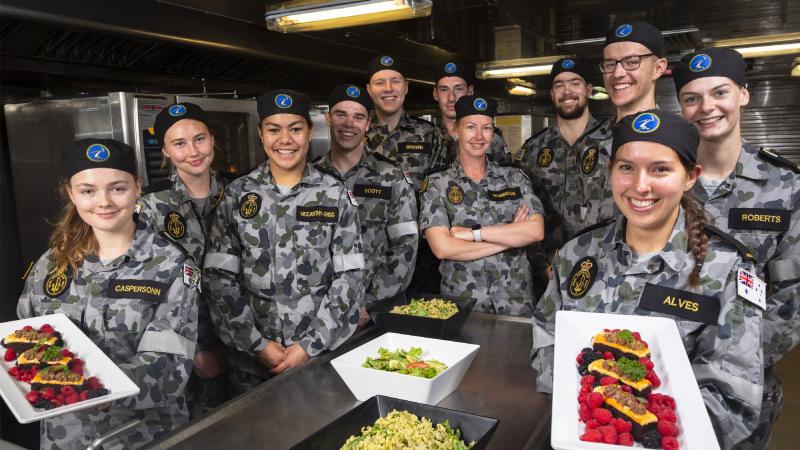  Petty Officer Maritime Logistics Chef Natalie Robinson, centre, with the gap year sailors and officers in the galley on board HMAS Adelaide during Exercise Sea Wader. Photo: Able Seaman Daniel Goodman