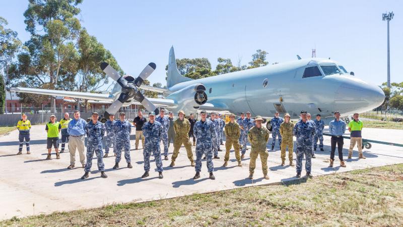 RAAF and Army personnel, with civilians, in front of the decommissioned AP-3C Orion at the front gate of RAAF Base Edinburgh. Photo: Leading Aircraftwoman Jacqueline Forrester
